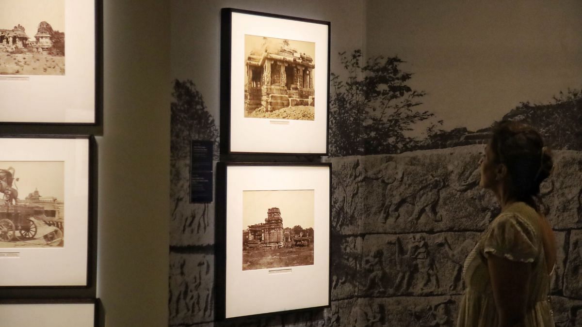 A woman looking at the first few photos of Indian archaeology photographed by Thomas Biggs | Photo: Manisha Mondal, ThePrint