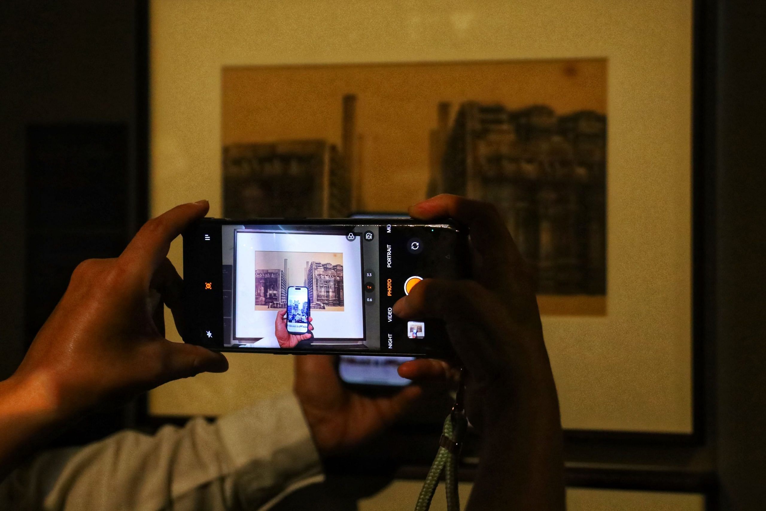 People at the exhibition juxtaposed old photos of monuments with current ones | Photo: Manisha Mondal, ThePrint