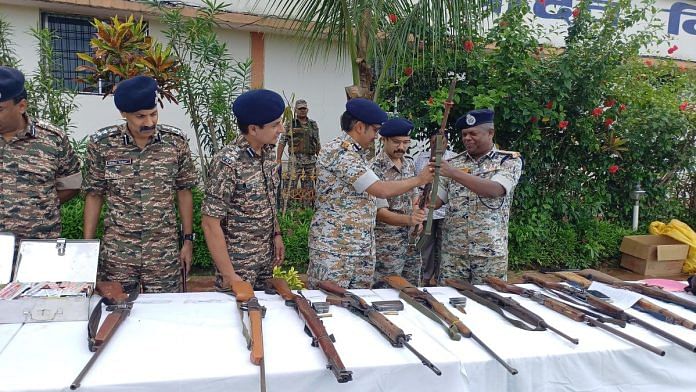 Security personnel with the arms recovered from the nine suspected Maoists who were killed Tuesday | By special arrangement