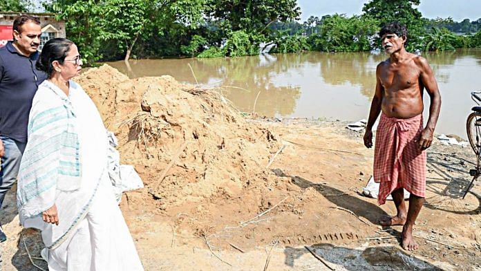 West Bengal Chief Minister Mamata Banerjee interacts with people during her visit to flood-affected areas on Wednesday. | ANI