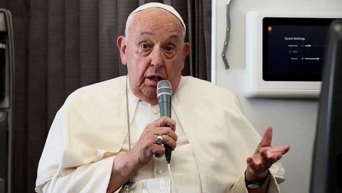 Pope Francis holds a news conference aboard the papal plane on his flight back after his 12-day journey across Southeast Asia and Oceania, September 13, 2024 | REUTERS/Guglielmo Mangiapane/Pool/File Photo