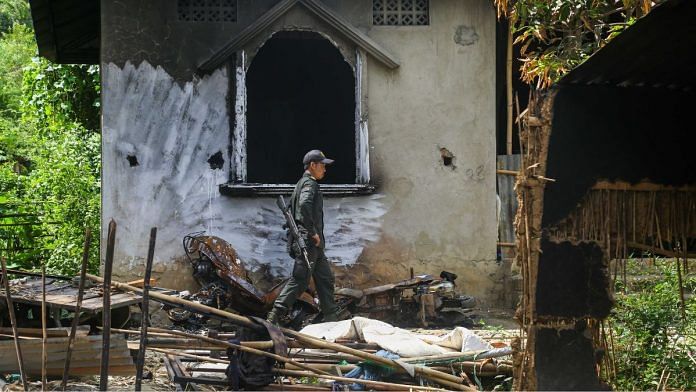 A security personnel walks in the rubble after drone bombing in Manipur village | Suraj Singh Bisht | ThePrint