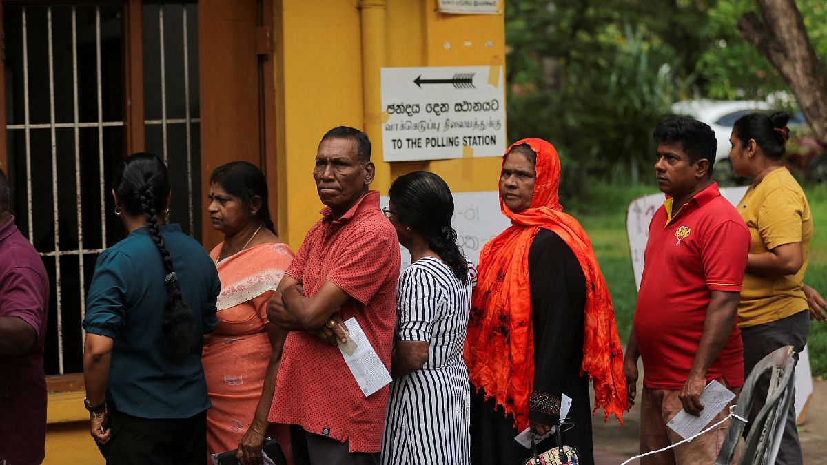 People stand in a queue to vote at a polling station during the presidential election in Colombo, Sri Lanka | REUTERS/Dinuka Liyanawatte