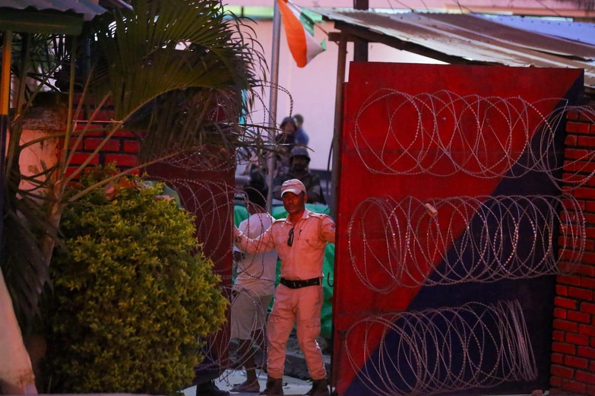 A police personnel closing the gate of SP office | Photo: Suraj Singh Bisht | ThePrint 