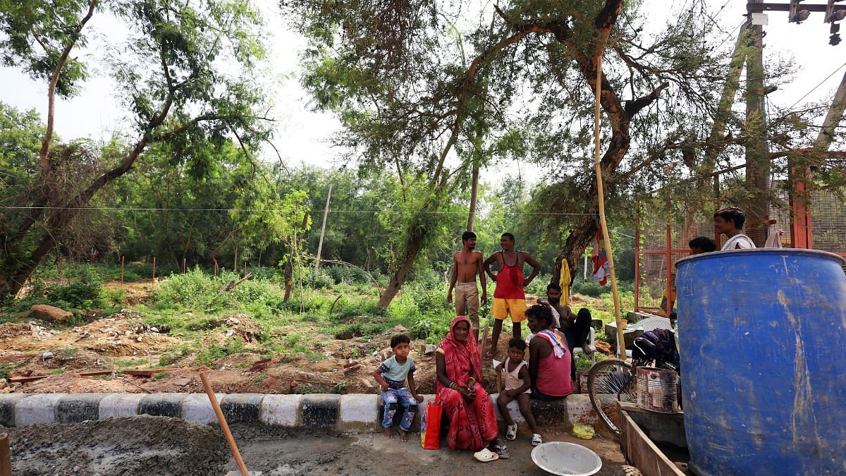 Workers involved in installation of the fence on the 1 km stretch of the road | Manisha Mondal | ThePrint