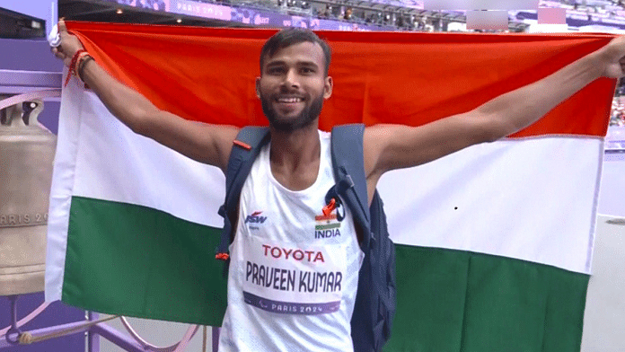 India's Praveen Kumar holds the tricolour flag after winning the Gold Medal in the Men's High Jump - T64 event at the Paris Paralympics 2024 | ANI