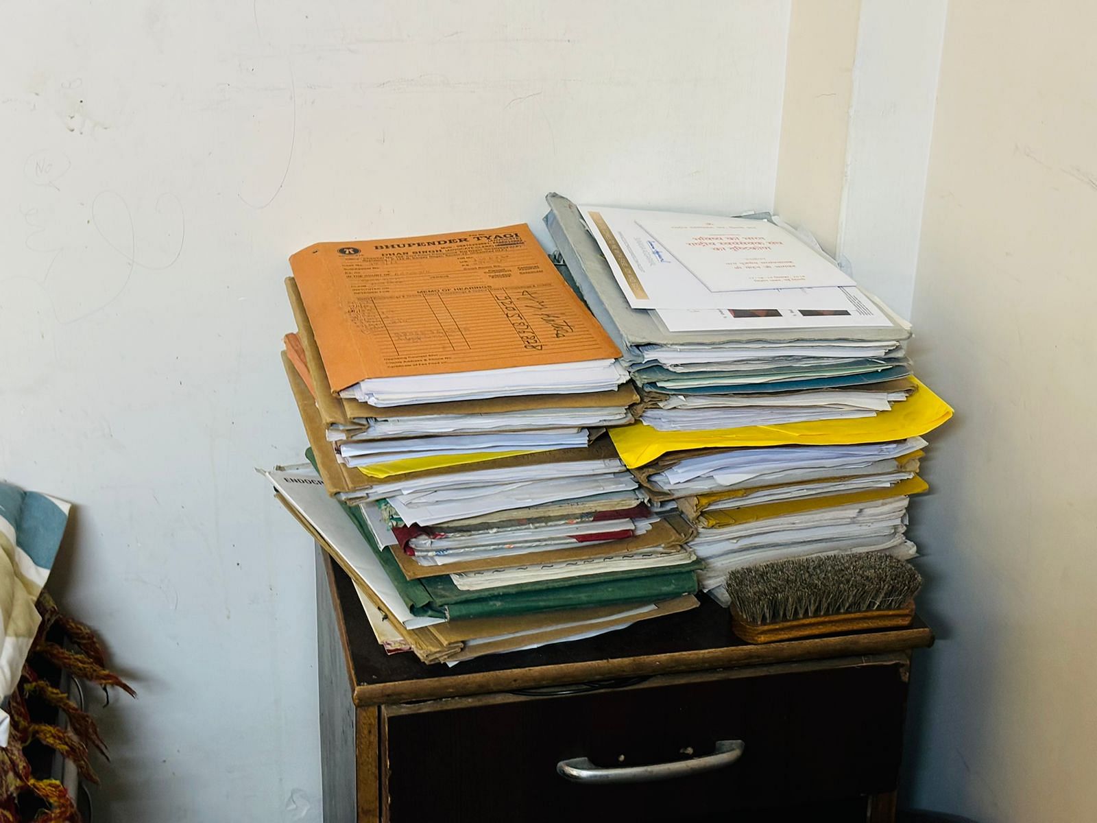 A pile of case files in a bedroom at Katara's house