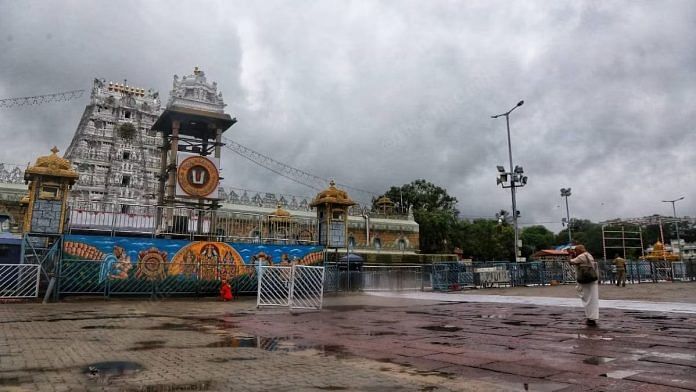 A devotee lifts his hands in prayer while standing in the outer courtyard of the Tirumala Tirupathi temple, in May 2020 | Manisha Mondal | ThePrint