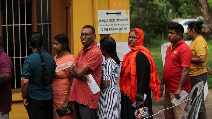 People stand in a queue to vote at a polling station during the presidential election in Colombo, Sri Lanka, September 21, 2024. REUTERS/Dinuka Liyanawatte