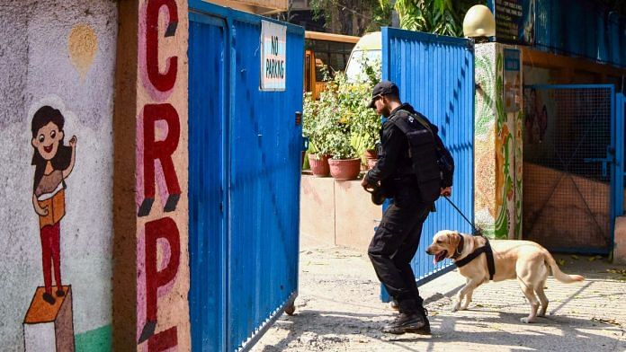 A National Security Guard (NSG) Commando with a sniffer dog carries out search operations at the blast site near CRPF School in Prashant Vihar, Rohini in New Delhi on 20 October | Photo: Ritik Jain | ANI File