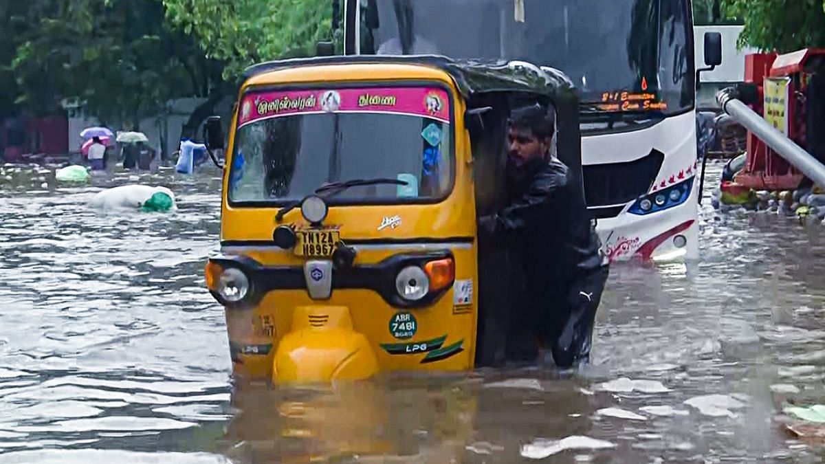 An auto driver wades through flooded streets following heavy rainfall in Chennai on 15 October | Photo: ANI