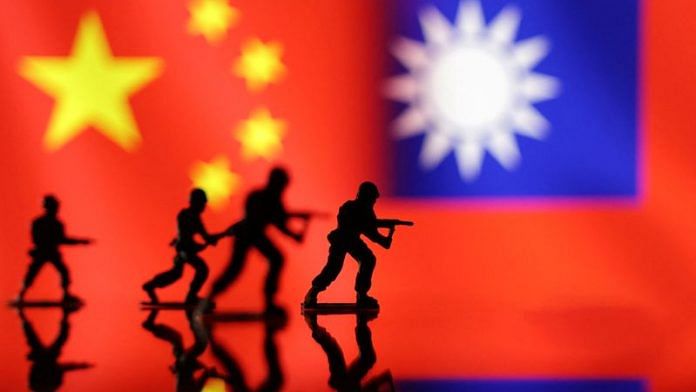 Solider miniatures are seen in front of displayed Chinese and Taiwanese flags in this illustration | Reuters/Dado Ruvic/Illustration/File photo