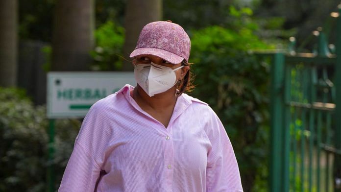 A woman is seen wearing a face mask at Lodhi Garden, in New Delhi/File photo/PTI