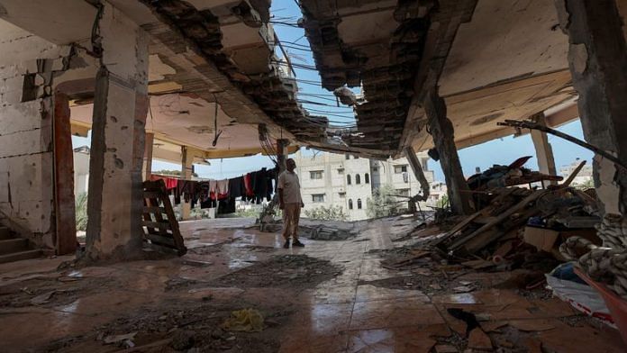 Palestinian Ahmed Mosran, whose son Yamen took his first polio vaccine in September and was killed in an Israeli strike before taking his second dosage, views the damage at his in-laws' house in Nuseirat in the central Gaza Strip, October 15, 2024. REUTERS/Ramadan Abed