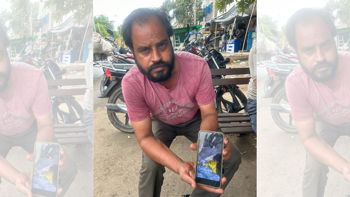 Gulrez Khan, a resident of Jahangirpuri shows a photo of his demolished shop | Zenaira Bakhsh | ThePrint