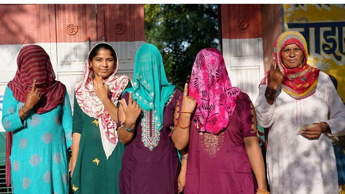 Women show their fingers marked with indelible ink after casting vote at a polling station at Balali village during the Haryana Assembly elections, in Charkhi Dadri district, Saturday -- PTI Photo/Shahbaz Khan