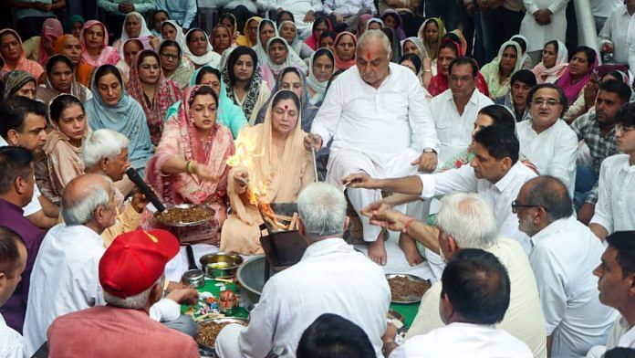 Haryana Leader of the Opposition and Congress candidate from the Garhi Sampla-Kiloi assembly constituency Bhupinder Singh Hooda performs havan ahead of his nomination filing for the upcoming state assembly elections, at his residence in Rohtak on Wednesday. His wife Asha Hooda, son Deepender Singh Hooda and daughter-in-law Shweta Mirdha Hooda are also present. | ANI