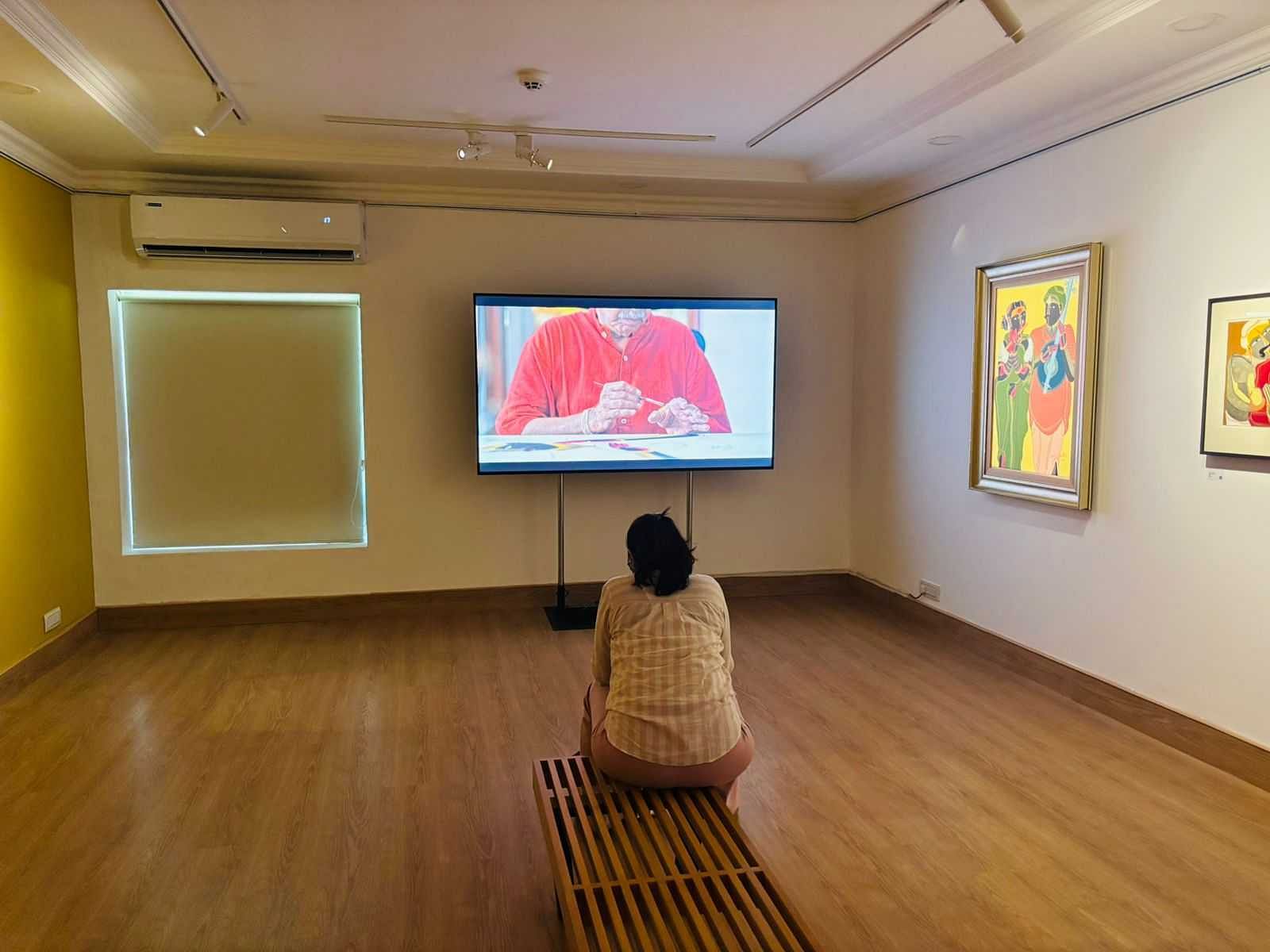 A visitor watching a short film on Vaikuntam's life that Art Alive Gallery put together | Vandana Menon, ThePrint