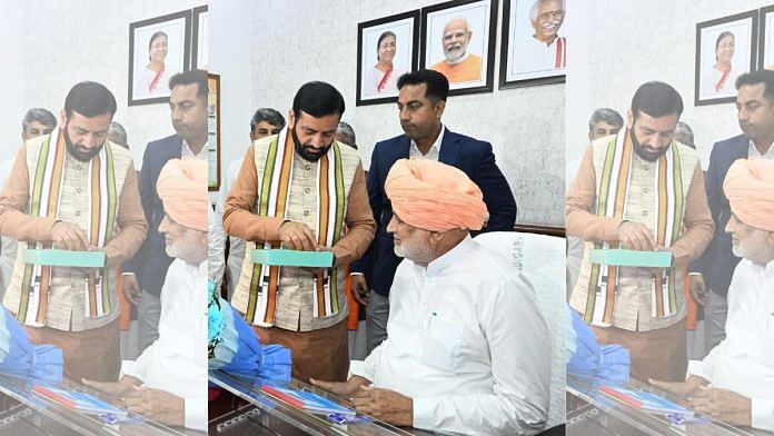 Haryana CM Nayab Saini (left) offers sweets to newly-appointed state agriculture minister Shyam Singh Rana | Source: X/@Teamshyamsingh