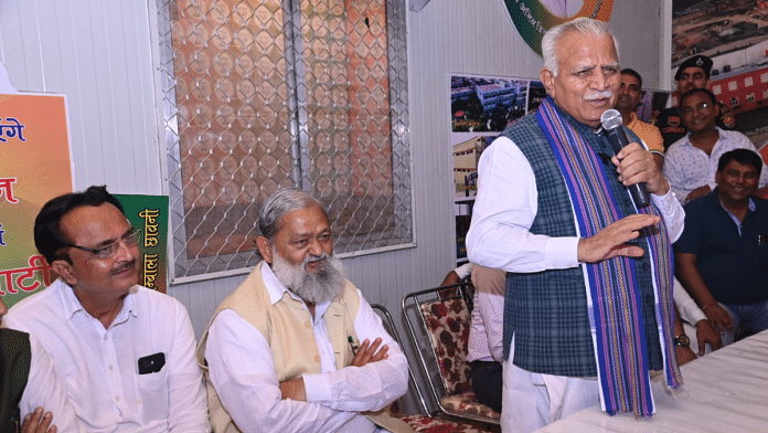 Former Haryana CM Manohar Lal Khattar (standing) while campaigning for BJP candidate Anil Vij (seated, second from left) in Ambala Cantt | X/@mlkhattar