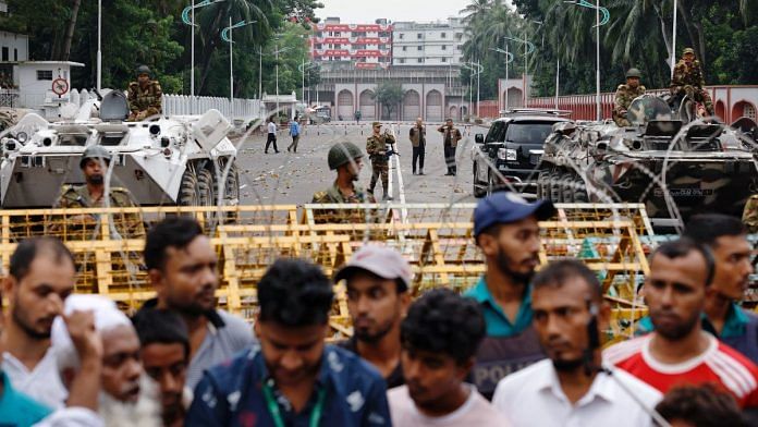 Amid protests in Dhaka, security personnel stand guard in front of Bangabhaban, the official residence of President Mohammed Shahabuddin | Reuters