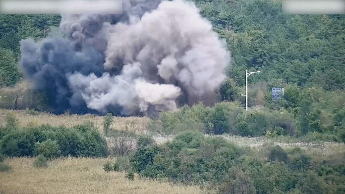 Smoke rises after North Korea blows up sections of inter-Korean roads on its side of the border between the two Koreas, according to South Korea's military, as seen from the South Korean side, October 15, 2024, in this screen grab from a handout video. South Korean Defence Ministry | Reuters