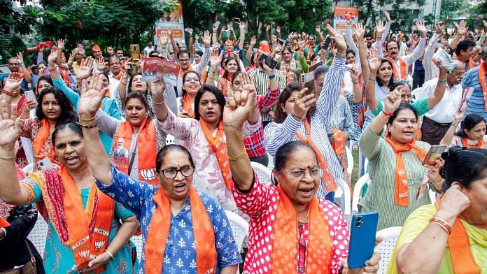 People raise slogans after receiving BJP membership cards during a membership drive, in Ahmedabad, on 25 September | ANI