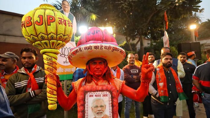 A BJP supporter outside party HQ in Delhi, Saturday | Manisha Mondal | ThePrint