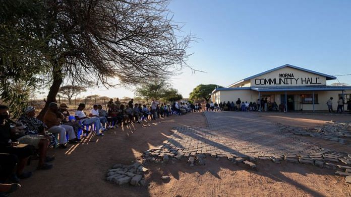 People wait to cast their votes in the 2024 general elections in Morwa village near Gaborone, Botswana Wednesday | REUTERS/Thalefang Charles