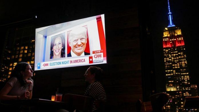 People attend a watch party at 230 Fifth Rooftop Bar, as the Empire State Building is seen in the background, in New York City, U.S., November 5, 2024 | Reuters