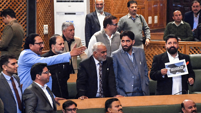 NC MLAs during a ruckus at J&K assembly over the passing of a resolution on the restoration of Article 370, in Srinagar on Wednesday | ANI