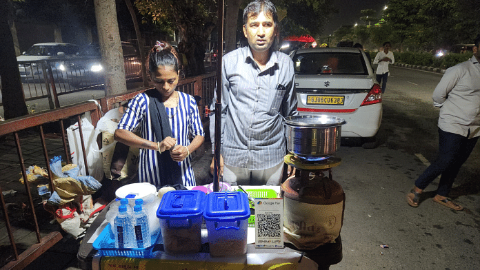 Diamond worker Rakeshbhai Dabhi with his wife at Ratnakalar stall on a street in Surat | Purva Chitnis | ThePrint