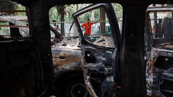 Vandalised cars at a police station in Dhaka on 6 August, after Sheikh Hasina's ouster | Reuters