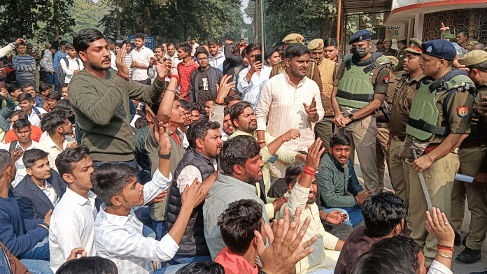 Police try to pacify students who were reciting Hanuman Chalisa on the campus of UP College following a notice by the Waqf Board, in Varanasi, on 3 December 2024. | PTI