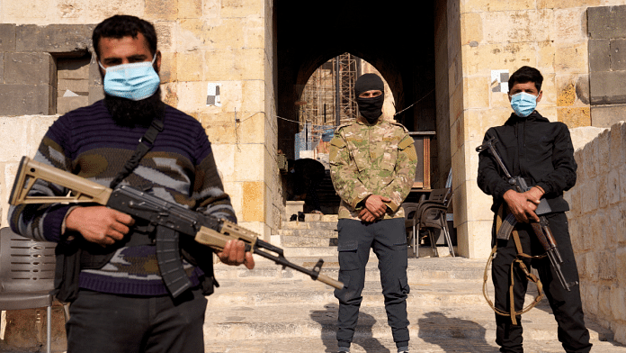 File photo of rebel fighters with weapons at the Citadel of Aleppo, after Syrian rebels announced that they have ousted Bashar al-Assad in Syria | REUTERS/Karam al-Masri