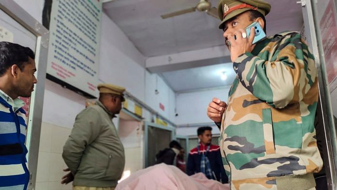 Police personnel and others stand near the body of one of the three terror suspects who, allegedly involved in the grenade attack in Gurdaspur, were killed in an encounter with a joint team of Uttar Pradesh and Punjab police, at a hospital, in Pilibhit, Monday, Dec. 23, 2024 | PTI