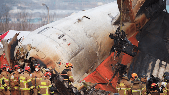 An excavator is used to lift burnt chairs from the wreckage of an aircraft that crashed after it went off the runway at Muan International Airport, in Muan, South Korea, on 29 December 2024. | Kim Hong-Ji | Reuters