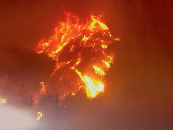 Thousands evacuate as fast-growing wildfires devastate Southern California amid harsh winds