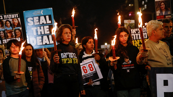 Supporters and family members of hostages kidnapped during the deadly October 7, 2023, attack on Israel by Hamas, hold lit torches during a protest ahead of a ceasefire between Israel and Hamas, in Tel Aviv, Israel, 16 January 2025 | Reuters/Shir Torem