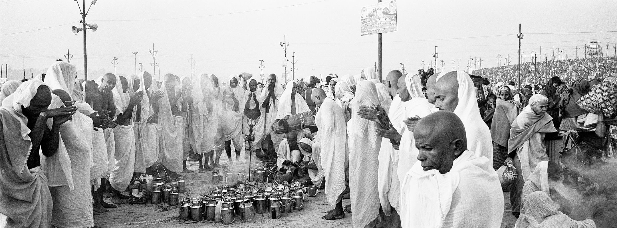Ardh Kumbh Mela 2007: A group of Kalpavasis huddle together to pray and sing devotional songs after bathing in the Sangam on Mauni Amavasya.