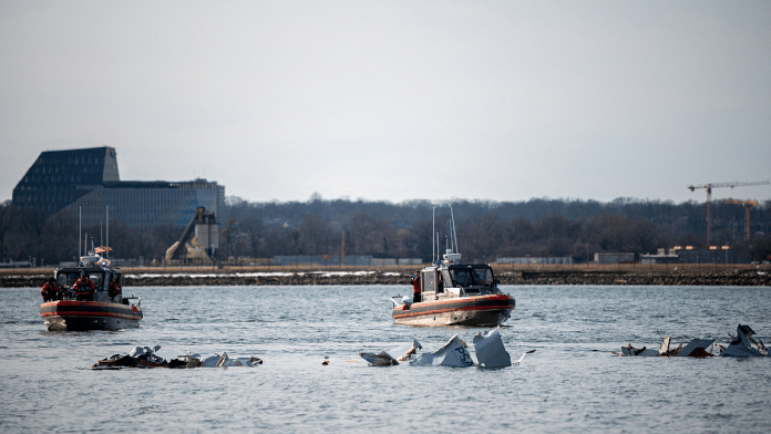 US Coast Guard, along with other search and rescue teams, operate near debris at the crash site in the Potomac River in a location given as Washington, in the aftermath of the collision of American Eagle flight 5342 and a Black Hawk helicopter that crashed into the Potomac River | Taylor Bacon/U.S. Coast Guard/Handout via Reuters