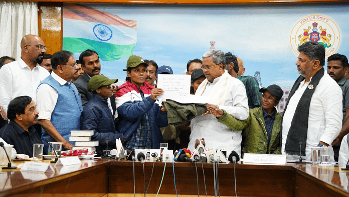 Karnataka CM Siddaramaiah (centre) with the surrendered Naxals in Bengaluru on Wednesday. Deputy CM D K Shivakumar (extreme right) is also seen at the event | Credit: Karnataka CMO