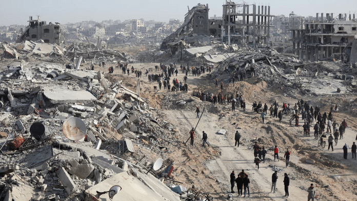 Displaced Palestinians walk past the rubble as they attempt to return to their homes in the northern Gaza Strip, on 19 January 2025. | Dawoud Abu Alkas | Reuters