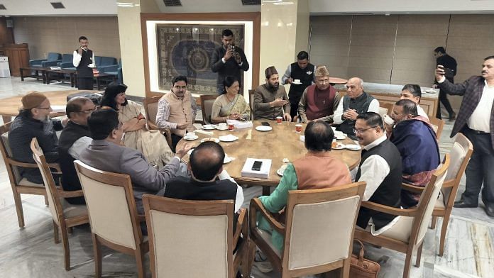 Members of the Joint Parliamentary Committee share a light moment during a meeting on the Waqf Amendment Bill, in New Delhi