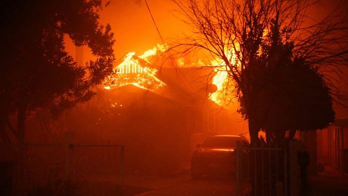 A house burns as powerful winds fueling devastating wildfires in the Los Angeles area force people to evacuate, at the Eaton Fire in Altadena, California, U.S. January 8, 2025 | Reuters