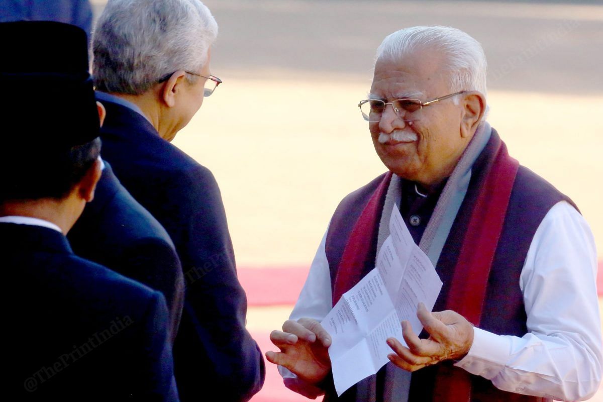 Union Minister Manohar Lal Khattar shows his schedule to Ajay Kumar Singh, the press secretary to the President | Praveen Jain | ThePrint