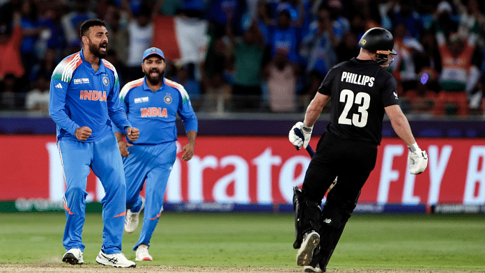 India's Varun Chakaravarthy (extreme left) celebrates the wicket of New Zealand's Glenn Phillips during ICC Champions Trophy 2025 in the group stage at Dubai | ANI