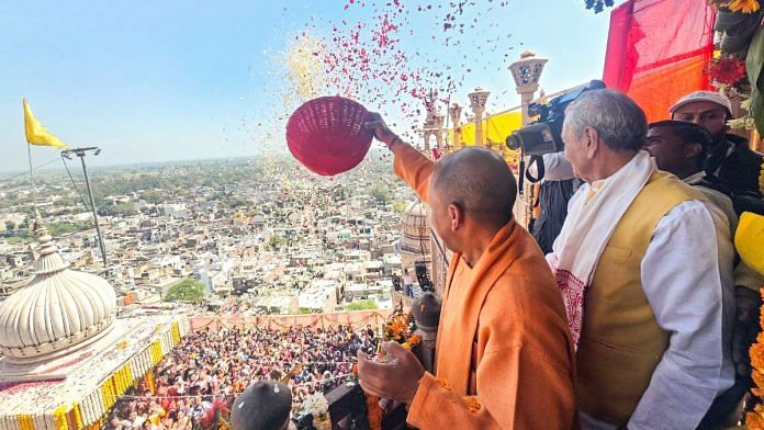 Representational image of Uttar Pradesh Chief Minister Yogi Adityanath showering flowers on devotees during 'Phoolon vali Holi' at Barsana in Mathura | ANI