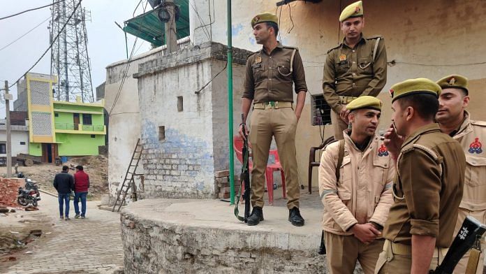 Police personnel stand at the disputed Dharani Varah Koop. The UP government in an affidavit submitted to the Supreme Court claimed that this well is situated near, and not inside, the Shahi Jama Masjid | Photo: Krishan Murari, ThePrint
