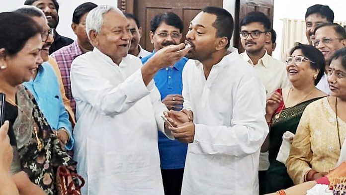 File photo of Bihar Chief Minister Nitish Kumar offering cake to his son Nishant Kumar on the occasion of his 49th birthday, in Patna | ANI